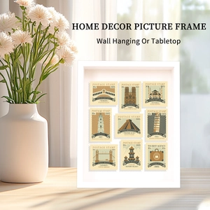 Macro view of white minimalist frame showing vintage world landmark stamps on a desk