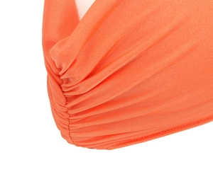 Detailed macro view of orange ribbed stretch fabric with ruched design and fine texture