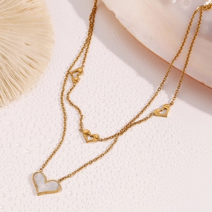 Detail of 18K gold-plated double-layer necklace with heart pendants and shell inlay