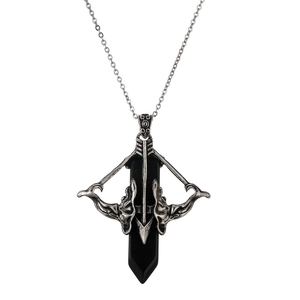 Macro detail of retro arrow pendant with black crystal stone and aged silver finish