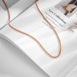Close-up detail of an elegant rose gold stainless steel curb chain with needle end