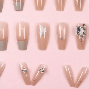 French cream press-on nails with silver glitter and rhinestone accents in long coffin shape