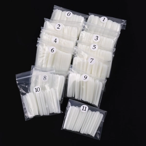 Detailed set of 12 sizes of extra long coffin fake nails in clear numbered individual bags