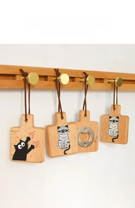 Set of four wooden cat paw bottle openers with creative illustrations and leather lanyards