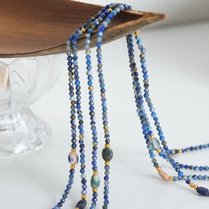 Handcrafted layered necklace with blue faceted natural stones and gold accent beads