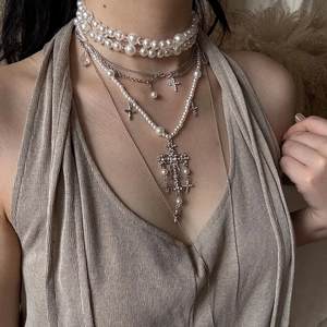 Baroque pearl layered necklace with vintage cross pendant on model's neck