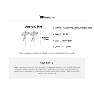Detailed view of rhinestone bow earrings with pearl tassels showing size dimensions
