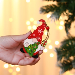 Close-up of wooden Christmas gnome ornament with red hat and hanging string