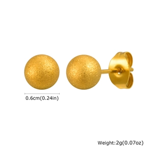 Detail of 0.6cm gold ball earrings with matte texture and butterfly back closure