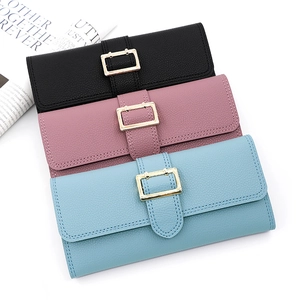Detailed view of lychee pattern leather wallets in black, pink, and blue with gold buckles