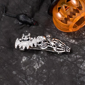 Detailed close-up of Halloween silver bat and skull hair clip with sparkling white rhinestones