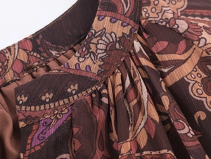 Close-up detail of paisley printed chiffon fabric with fine stitching for holiday dress