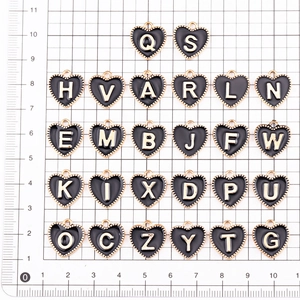Black enamel heart pendants with gold A-Z letters and ruler for size reference