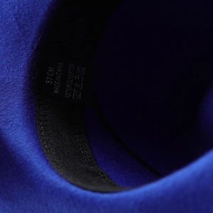 Detailed interior view showing 57cm size label and sweatband of the blue fedora hat