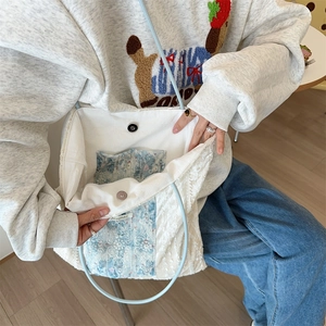 Detail view of large lace tote bag with floral cotton lining and secure magnetic closure
