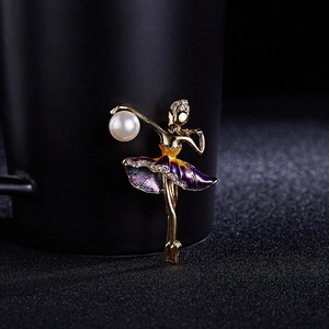 Close-up of ballet dancer brooch with purple enamel tutu and white pearl accent