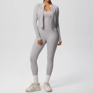 Three-piece light grey yoga set with cropped zip jacket, sports bra, and high-waist leggings