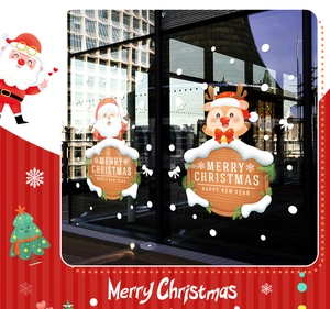 Detail of Christmas Santa and Reindeer static window stickers on a glass surface