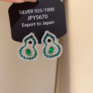 Detail view of 925 silver gourd earrings with green gems and white zircon micro-inlay