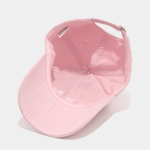 Close-up of pink cotton baseball cap interior with adjustable buckle and wash label