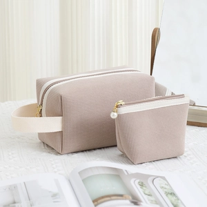 Beige waffle corduroy makeup bag set with top handle and gold zippers for travel storage