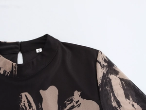 Close-up of mock neck mesh dress with abstract print and back cutout button detail