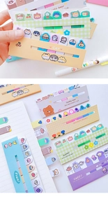Detailed view of colorful cartoon bear and flower sticky notes used in a notebook