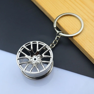 Macro detail of high-polish silver alloy car wheel hub keychain with metallic links