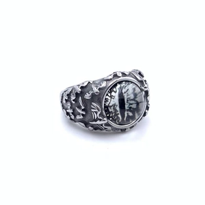 Close-up of gothic demon eye ring with silver eagle wings and black white eyeball inlay