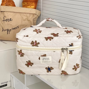 Quilted cream stripe cosmetic bag with cute brown bear patterns and top handle