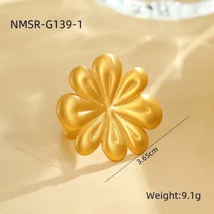 Golden flower statement ring in matte finish stainless steel with an open adjustable band