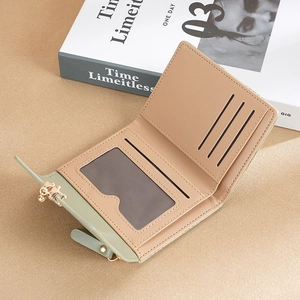 Green PU leather short wallet featuring multi-slot interior and bifold snap button design