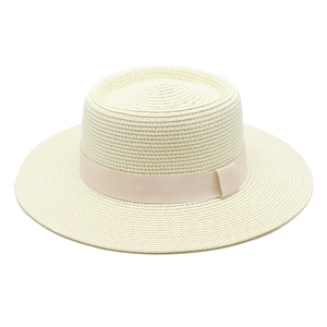 Detail of off-white straw boater hat with fine weaving and elegant pink satin ribbon band