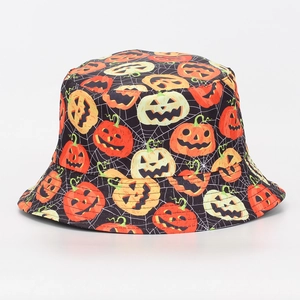 Close-up of Halloween bucket hat featuring orange pumpkin and spider web print details