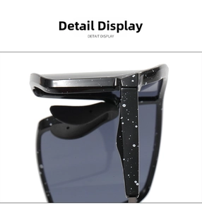 Detailed macro view of black sport sunglasses hinge with white speckled paint finish