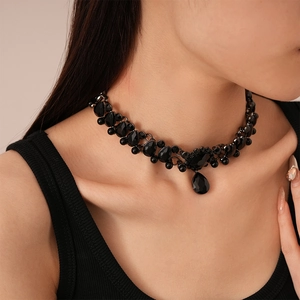 Detailed view of vintage black gemstone choker with teardrop pendant on model neck