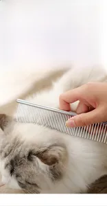 Detail view of the fine stainless steel teeth grooming a long-haired white cat