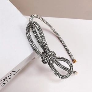 Sparkling silver rhinestone headband with bow detail on a clean white background