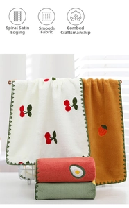 Close-up of coral fleece face towels with fruit embroidery and wavy edge lock stitching