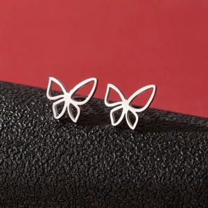 Detailed close-up of shiny silver butterfly stud earrings with cutout design