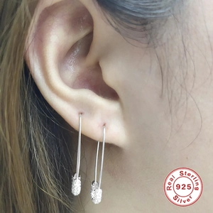 S925 sterling silver safety pin earrings with sparkling zircon stones on model