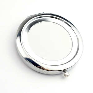 Portable silver round double-sided metal folding makeup mirror on a white background