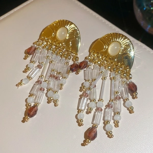 Detailed shot of vintage beaded tassel earrings with gold accents and opal stones