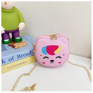 Pink silicone cartoon animal crossbody bag with gold chain strap on white table