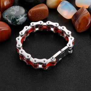 Macro detail of industrial style 304 stainless steel chain bracelet with red accents
