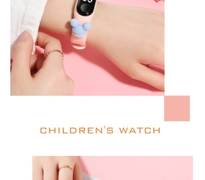Macro view of pink silicone children's LED watch with a blue 3D cartoon charm detail