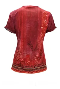 Detail view of the bohemian floral print and ethnic vine patterns on the back of red T-shirt