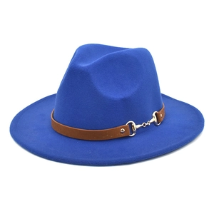 Close-up of a navy wool fedora with a brown leather band and gold horsebit detail
