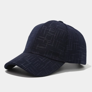 Detailed view of navy baseball cap featuring modern geometric grid texture and reinforced brim