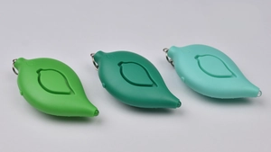 Detailed view of leaf-shaped personal alarms in green colors with metallic keychains